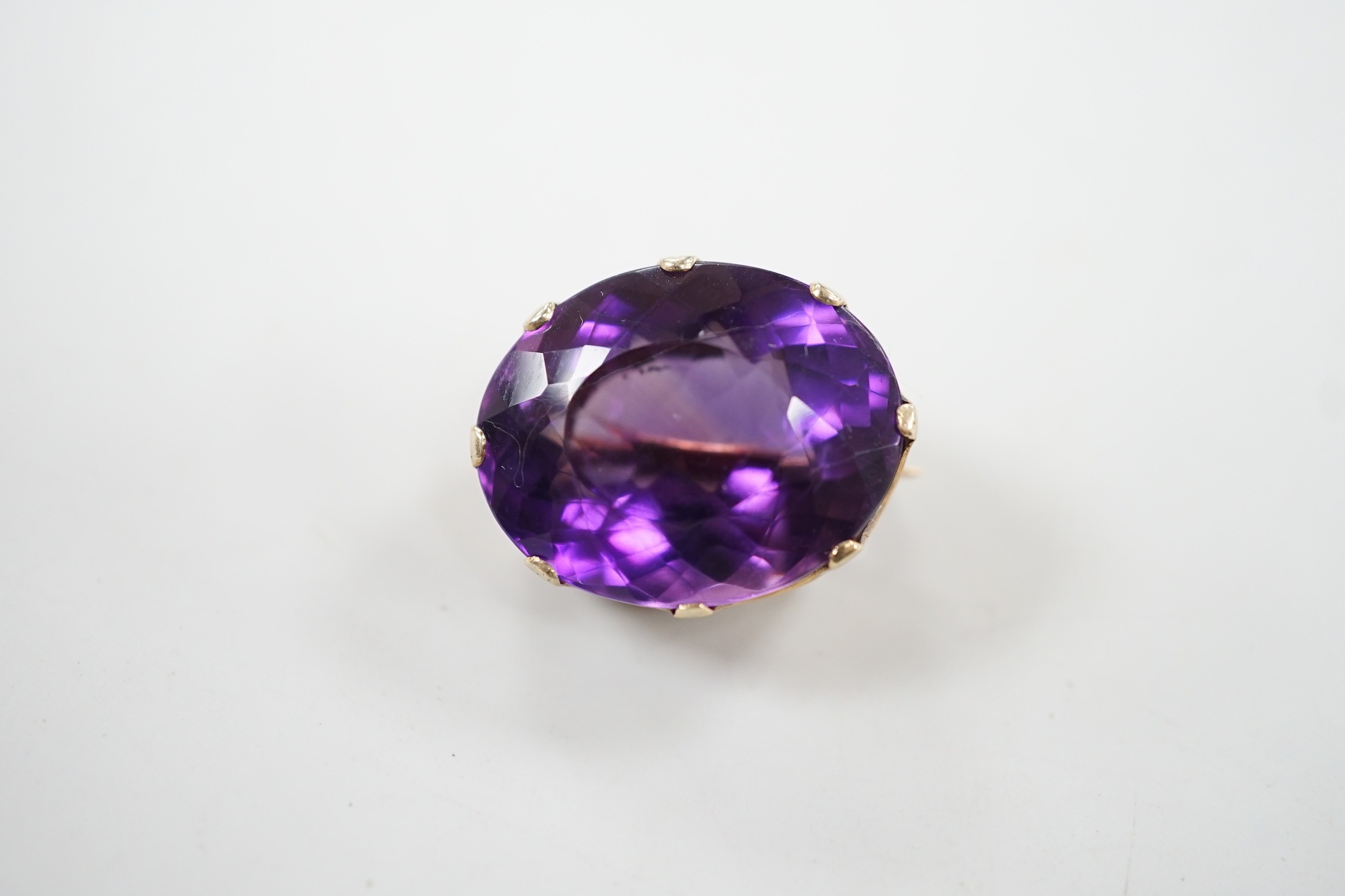 A modern 9ct gold mounted oval facet cut amethyst brooch, 22mm, gross weight 8.5 grams.